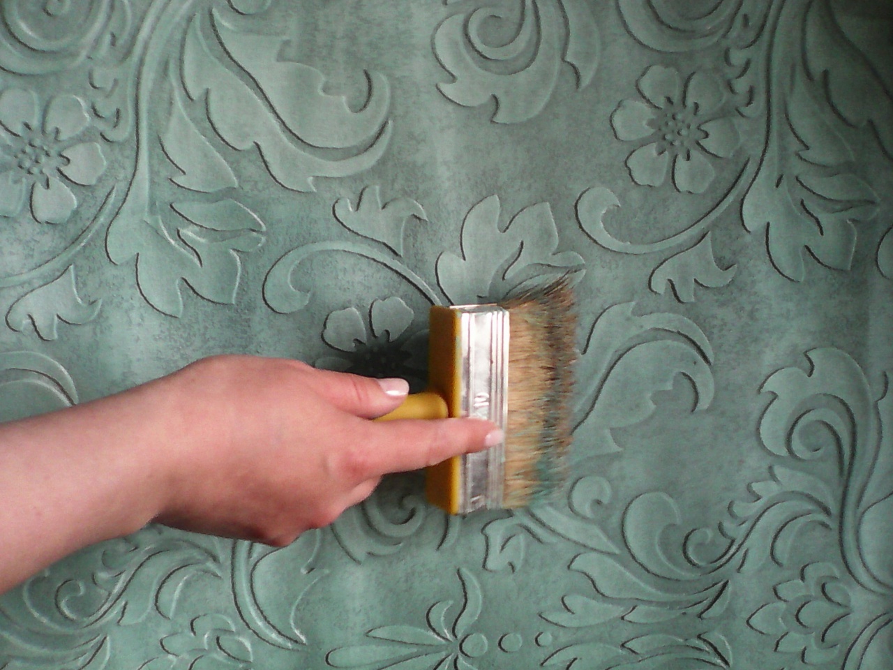 Paint background by roller in main color and stamp with "dry brush" technique in two colors to produce the effect of oxidation and patina.